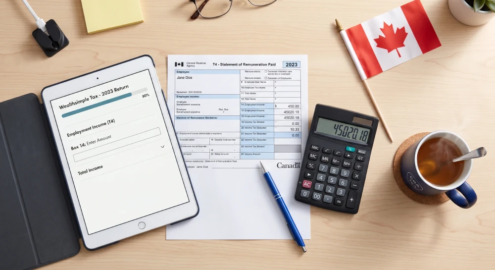 Organizing T4 slips and paperwork for filing taxes as a newcomer in Canada